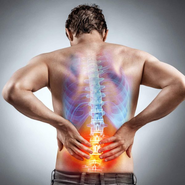 Lower back pain. Man holding his back in pain. Medical concept.