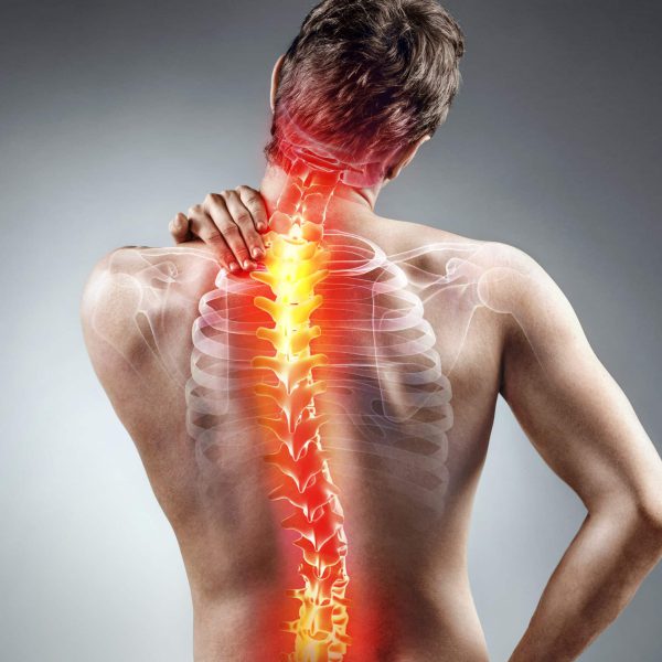 Young man holding his neck in pain. Medical concept.